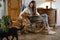 Person with golden retriever dog on rocking chair at home