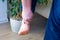 Person grabbed with hand of achilles tendon or heel cord due to severe pain. Concept photo of symptoms and disease and injury of a