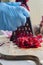 Person grating fresh raw beetroot with a metal grater in a kitchen