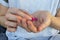 Person hand with pills. Woman holding two pink pills in hand. Healthcare, medicine concept. Patient take medicament, supplements,