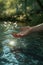 person hand splashing water drops at lake or river, human palm splash aqua