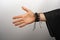 Person hand with traditional leather bracelets and kimano against a white wall