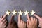 Person Hands Aligning Five Star Rating Icons