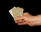 Person hands are holding playing cards and the ACE of diamonds on black background closeup. Idea for a casino or poker club