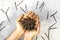 Person hands holding rusty nails on gray background