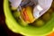 Person hands with knife cutting walnut husk