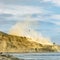 Person hanging on a helicopter over Sunset Cliffs