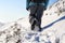 Person hiking on the mountaintop covered with snow low angle view