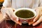 Person holding bowl of therapeutic Traditional Chinese Medicine