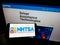 Person holding cellphone with logo of National Highway Traffic Safety Administration (NHTSA) on screen with web page.