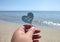 Person holding fingers stick shape heart words Love you background sand beach