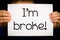 Person holding I am broke sign