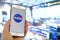 A person holding a iPhone with the NASA logo with a out of focus