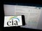 Person holding mobile phone with logo of American Energy Information Administration (EIA) on screen with web page.