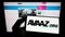 Person holding mobile phone with logo of American nonprofit organization Avaaz on screen in front of web page.
