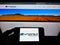 Person holding mobile phone with logo of Australian mining company Argonaut Resources NL on screen in front of web page.