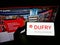 Person holding mobile phone with logo of Swiss retail company Dufry AG on screen in front of business web page.