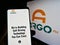 Person holding mobile phone with website of American driving technology company Argo AI LLC on screen in front of logo.