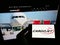 Person holding monbile phone with business logo of Canadian cargo airline Cargojet Inc. on screen in front of web page.