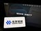 Person holding smartphone with logo of Chinese mining company Huayou Cobalt Co. Ltd. on screen in front of website.