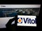 Person holding smartphone with logo of Dutch trading company Vitol Holding B.V. on screen in front of website.