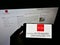 Person holding smartphone with logo of German education institution University of Mainz on screen in front of web page.