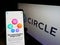 Person holding smartphone with webpage of US payment company Circle Internet Financial Ltd on screen with logo.