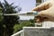 Person holding a thermometer on his balcony