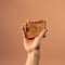 Person Holding Toast On Beige Background: A Ray Tracing And Dutch Golden Age Inspired Advertising Shot