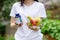 person holding vitamins and bowl of fruit and vegetables