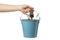 Person holds bucket with gardening tools, isolated on background