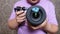 Person holds camera with large lens and adjusts focus for shooting.