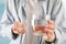 Person holds pills and glass of water