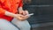 A person holds a smartphone in his hands and types a message