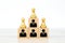 Person individual people icons and chess on wooden toy blocks stacked in pyramid.