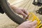 A person inflates a Bicycle wheel with compressed air. Soft focus.