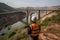 Person inspecting large-scale infrastructure project with a drone.