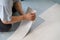 A person installing new vinyl tile floor, a DIY home project