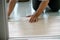 A person installing new vinyl tile floor, a DIY home project