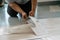 A person installing new vinyl tile floor, a DIY home project