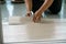 A person installing new vinyl tile floor, a DIY home project