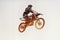 Person, jump and motorcyclist in the air for extreme sports, trick or outdoor stunt in sunset on mockup. Expert rider on