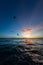 Person kitesurfing during the breathtaking sunset reflecting in the ocean in Bonaire, Caribbean