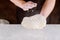 Person kneading pizza dough in hands for making pizza