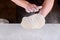 Person kneading pizza dough for pizza making