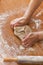 A person kneading the whole pizza dough