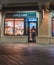 Person leaving a market decorated with neon lights captured from outside in Atlantic city, USA