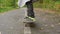 Person legs feet skateboard city road closeup