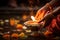 Person lighting a candle in a bowl