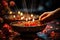 a person lighting candles on a bowl of food